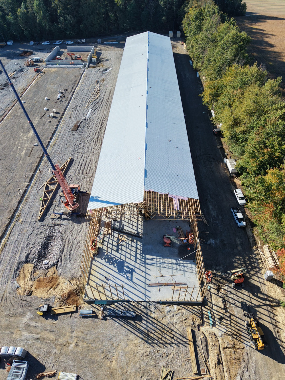 Aerial view looking down the length of a framed building with metal roof